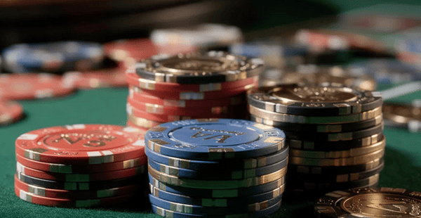 The image features a vibrant array of colorful casino chips stacked neatly on a green felt table, evoking the lively atmosphere of an online casino. These chips represent various denominations and are often associated with exciting casino games and bonuses, such as free spins and deposit bonuses.