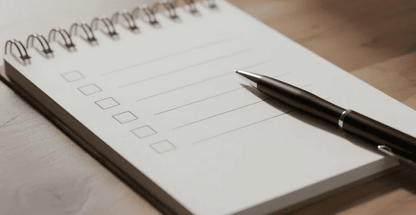 The image features a notepad displaying a checklist alongside a pen, all resting on a wooden desk. This scene suggests organization and planning, possibly related to managing casino bonuses or online casino promotions.